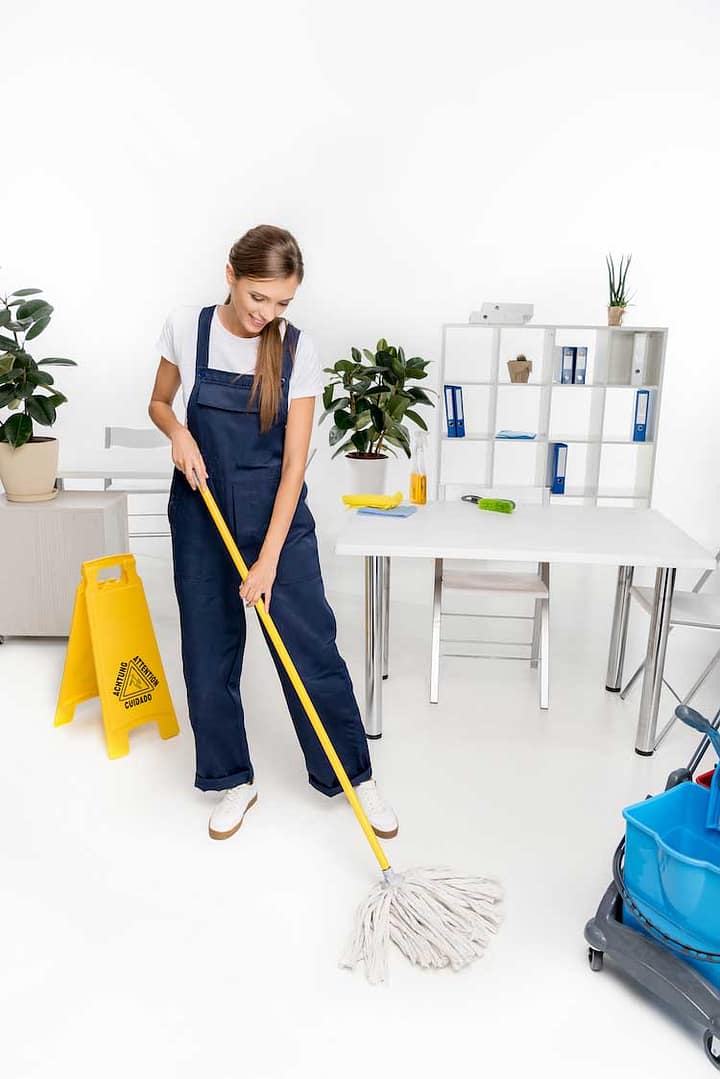 smiling-young-cleaner-washing-floor-with-mop-VD43LT4 commercial cleaning