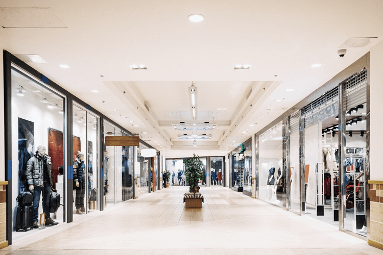 shops-with-clothes-at-the-modern-shopping-mall-sho-E42C4XJ